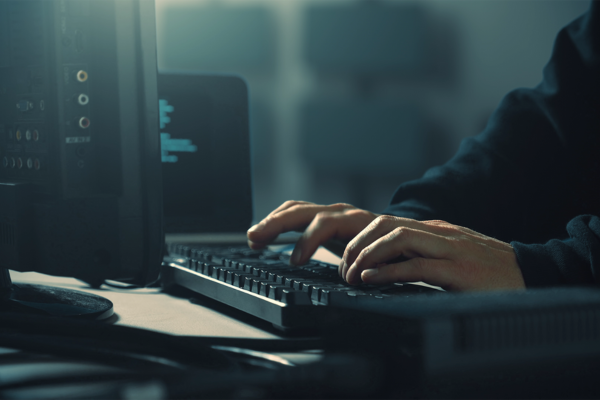 Hacker typing on keyboard